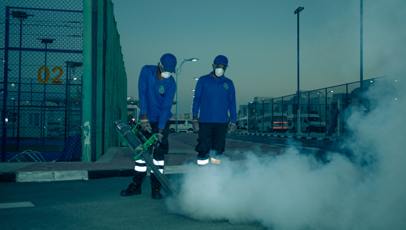 Staff using cleaning machine outdoors