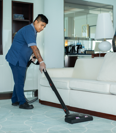 Staff member vacuuming